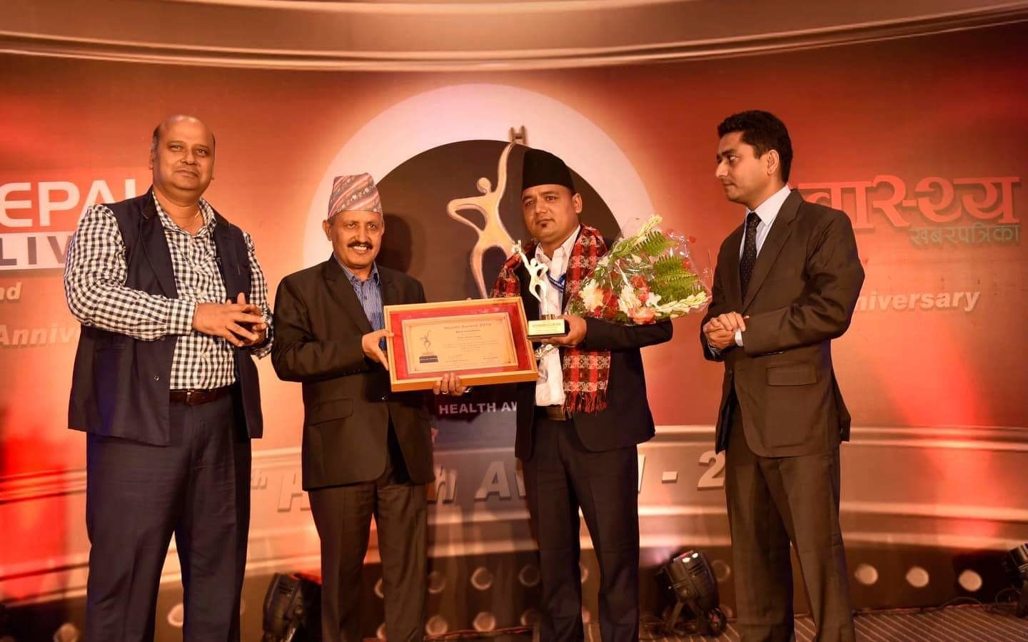 Health worker Rajan Thapa receiving the Health Award 2019 on stage